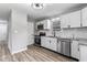 Updated kitchen boasting stainless steel appliances, white cabinets, and granite countertops at 360 Richie Ave, Indianapolis, IN 46234