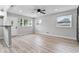 Bright living room featuring hardwood floors, new paint, and natural light from multiple windows at 360 Richie Ave, Indianapolis, IN 46234