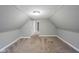 Finished attic area with neutral walls and carpet, offering versatile living space at 410 Plum St, Frankton, IN 46044
