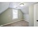 Well-lit attic bedroom with a window, neutral walls, carpet and bead board ceiling at 410 Plum St, Frankton, IN 46044