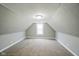 Bright attic bedroom with a window, neutral walls, carpet and sloped ceilings at 410 Plum St, Frankton, IN 46044