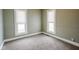 Bedroom with two windows letting in natural light, neutral walls, and plush carpeting at 410 Plum St, Frankton, IN 46044