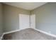 Spacious bedroom with neutral walls, plush carpeting, and a closet for ample storage at 410 Plum St, Frankton, IN 46044