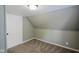 Attic space with neutral walls, carpet, bead board ceiling and a closed door at 410 Plum St, Frankton, IN 46044