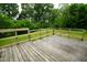 A wooden deck with a wooden railing overlooks the backyard at 410 Plum St, Frankton, IN 46044