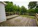 Side view of a wooden deck with a railing that overlooks the lawn at 410 Plum St, Frankton, IN 46044
