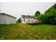Exterior view of the home and detached garage with a wooden deck at 410 Plum St, Frankton, IN 46044