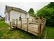 Side view of the home's exterior highlighting the wooden deck at 410 Plum St, Frankton, IN 46044