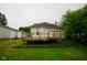 Exterior view of the home featuring the deck and grassy backyard at 410 Plum St, Frankton, IN 46044
