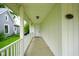 Charming front porch with white railings leads to the home's entrance, marked by the house number at 410 Plum St, Frankton, IN 46044