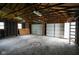 Spacious garage interior with multiple windows and two garage doors, great for storage and projects at 410 Plum St, Frankton, IN 46044