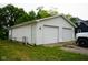Spacious detached two-car garage offers ample parking and storage with an adjacent access door at 410 Plum St, Frankton, IN 46044