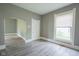 Inviting living room with hardwood floors, large window, and an open doorway at 410 Plum St, Frankton, IN 46044