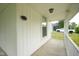 Exterior view of the home's covered porch with a view of the driveway at 410 Plum St, Frankton, IN 46044