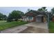 Single-story brick home with carport for two vehicles and well-maintained landscaping at 420 Brookside Ln, Plainfield, IN 46168