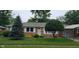 Charming single-story brick home featuring a well-maintained lawn and mature trees at 420 Brookside Ln, Plainfield, IN 46168