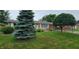 Charming single-story brick home featuring a well-maintained lawn and mature trees at 420 Brookside Ln, Plainfield, IN 46168