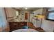 Well-lit kitchen features white cabinets, modern appliances, bar seating, and hardwood floors at 420 Brookside Ln, Plainfield, IN 46168