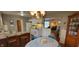 Bright eat-in kitchen with white cabinets, modern appliances, and view of the living room at 420 Brookside Ln, Plainfield, IN 46168