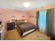 A bedroom includes a queen-sized bed, a chest of drawers, and a window with curtains at 4329 Rutgers Dr # 40B, Anderson, IN 46013