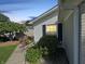 A charming side view of a home with a landscaped garden, showcasing vibrant pink flowers and lush greenery at 4329 Rutgers Dr # 40B, Anderson, IN 46013