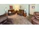 Comfortable living room featuring two sofas, side tables with lamps, and decorative wall hangings at 4329 Rutgers Dr # 40B, Anderson, IN 46013