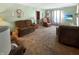 Inviting living room featuring plush sofas, a decorative display cabinet, and ample natural light at 4329 Rutgers Dr # 40B, Anderson, IN 46013