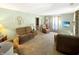 Inviting living room featuring plush sofas, a decorative display cabinet, and ample natural light at 4329 Rutgers Dr # 40B, Anderson, IN 46013