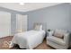 Inviting bedroom with wood floors, accent chair, and closet access at 44 Horseshoe Ln, Carmel, IN 46033
