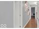 Upstairs hallway with sleek hardwood flooring and modern artwork at 44 Horseshoe Ln, Carmel, IN 46033