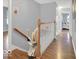 Upstairs hall featuring chair lift on hardwood staircase, offering accessibility between floors at 44 Horseshoe Ln, Carmel, IN 46033