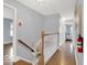 Upstairs hall featuring chair lift on hardwood staircase, offering accessibility between floors at 44 Horseshoe Ln, Carmel, IN 46033