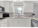 Bright kitchen with white cabinets, stainless steel appliances, and marble countertops at 44 Horseshoe Ln, Carmel, IN 46033