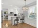 Stylish kitchen with white cabinets, bar seating, and modern appliances for a functional space at 44 Horseshoe Ln, Carmel, IN 46033