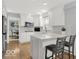 Bright kitchen with white cabinets, stainless steel appliances, and hardwood floors at 44 Horseshoe Ln, Carmel, IN 46033