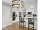 Inviting kitchen with breakfast bar, stainless appliances and modern lighting that enhances the cooking experience at 44 Horseshoe Ln, Carmel, IN 46033