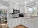 Modern kitchen with stainless steel appliances, white cabinets and marble countertops at 44 Horseshoe Ln, Carmel, IN 46033