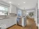 Modern kitchen with stainless steel appliances, white cabinets, and an island at 44 Horseshoe Ln, Carmel, IN 46033