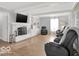 Open-concept living area with a fireplace, built-ins, and hardwood flooring at 44 Horseshoe Ln, Carmel, IN 46033