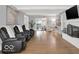 Large living room featuring hardwood floors, a fireplace, and comfortable seating at 44 Horseshoe Ln, Carmel, IN 46033