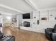 Spacious living room with hardwood floors, fireplace, and built-in shelving at 44 Horseshoe Ln, Carmel, IN 46033