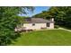 Aerial view of a home's backyard with green lawn, patio set, and mature trees at 453 N 275 E, Columbus, IN 47203