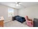 Bedroom featuring a window with natural light, a ceiling fan, and a pink armchair at 453 N 275 E, Columbus, IN 47203
