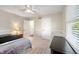 Bedroom features a ceiling fan, a window with natural light, and a closet door at 453 N 275 E, Columbus, IN 47203