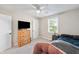 Bedroom featuring a window with natural light, a ceiling fan, and a wooden dresser at 453 N 275 E, Columbus, IN 47203