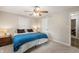 Bedroom with light walls, carpet, ceiling fan, and ensuite bathroom door at 453 N 275 E, Columbus, IN 47203