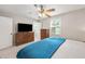 Bedroom featuring carpet, a ceiling fan, and a wood dresser with a TV at 453 N 275 E, Columbus, IN 47203