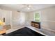 Bedroom featuring a ceiling fan, a window with natural light, and a dresser with wicker baskets at 453 N 275 E, Columbus, IN 47203