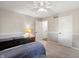 Bedroom featuring a ceiling fan, neutral palette, and bedside table with a lamp and bedroom entry at 453 N 275 E, Columbus, IN 47203