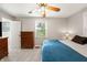 Bedroom with carpet and a window, featuring a dresser and a lamp at 453 N 275 E, Columbus, IN 47203
